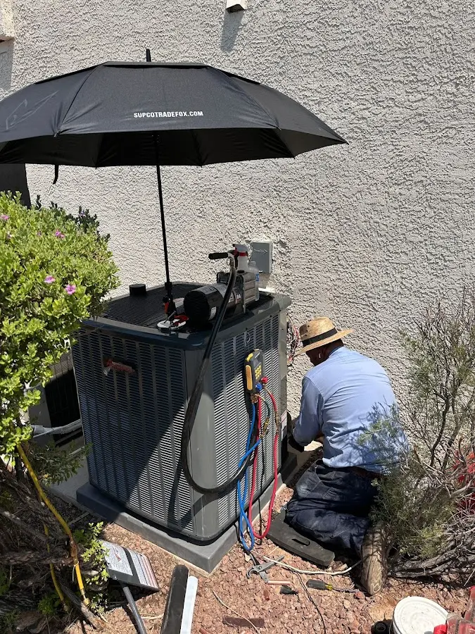 HVAC technician performing outdoor AC maintenance in Collinsville